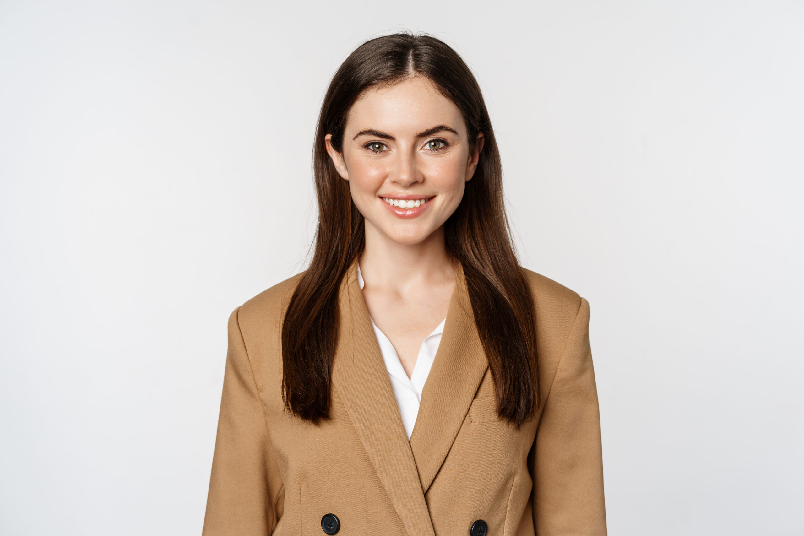 Portrait of business woman with enthusiastic face expression, smiling, looking confident, standing in suit over white background